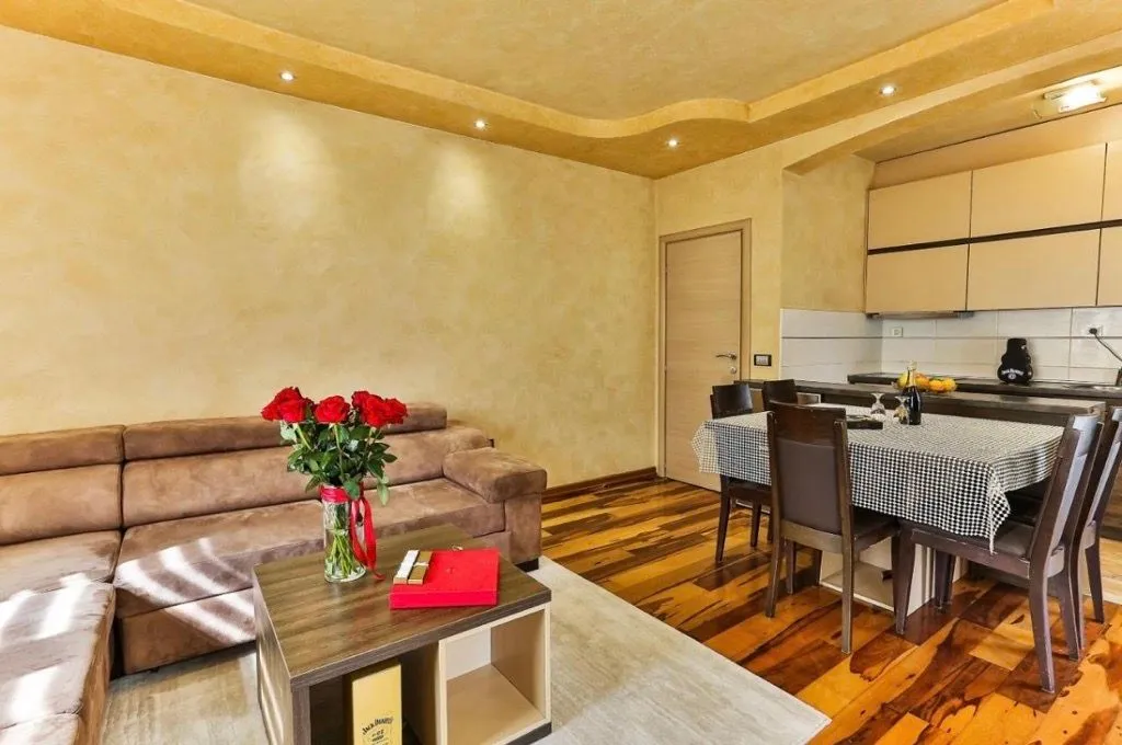 Living room with a sofa set and an adjoining dining area.