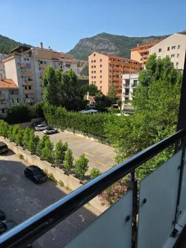 Pogled sa terase na zgrade, parking i okolne planine. - image 9