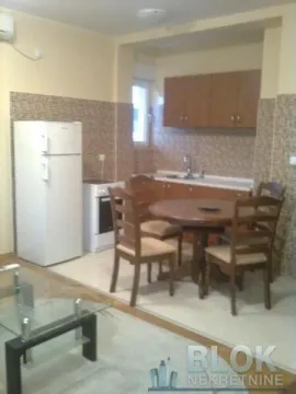 Kitchen with a dining area and wooden cabinetry. - image 5
