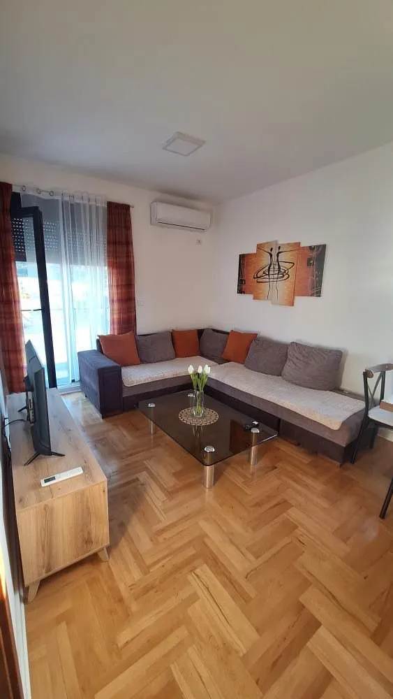 Living room with a sectional sofa, coffee table, and TV.