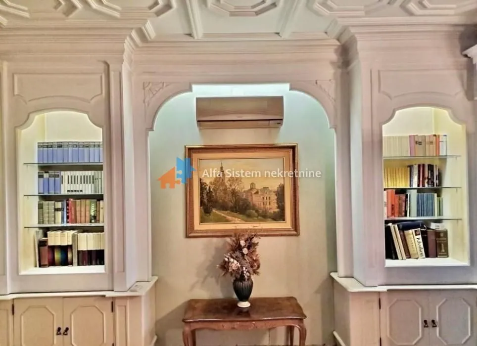 Living room with built-in bookshelves and decorative wall panels.