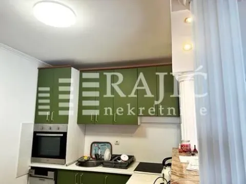 Small kitchen with green cabinets and a built-in appliance. - image 11