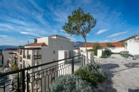 View of the building's exterior area with a swimming pool and landscaped terrace. - image 6