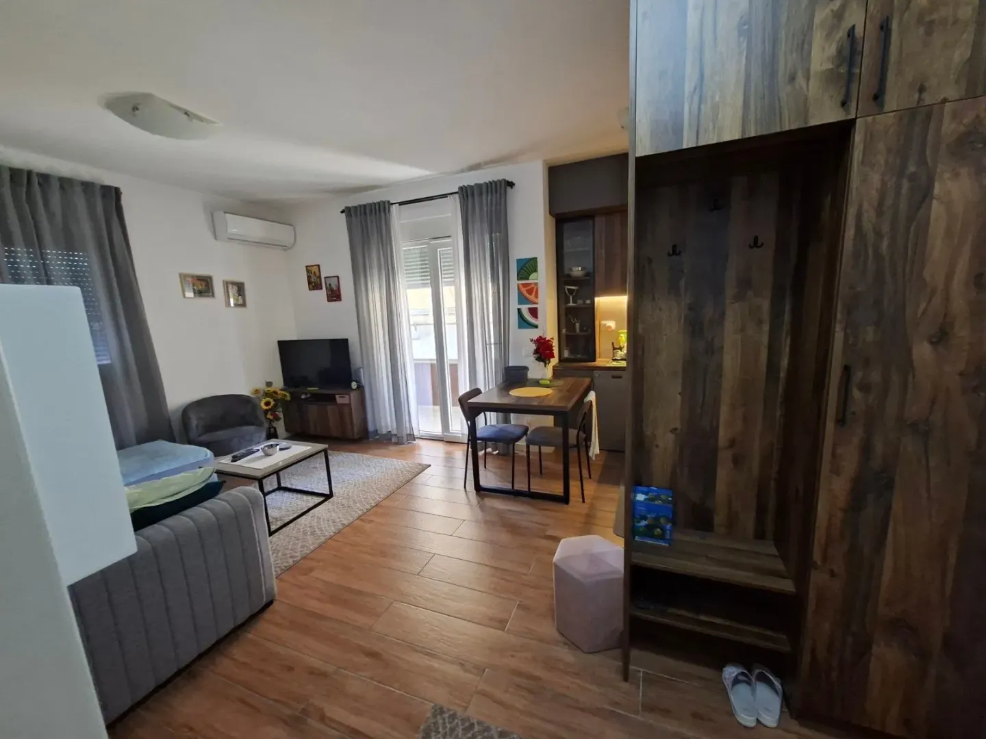 Living room with a dining area and kitchen in the background.