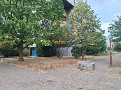 View of the green area in front of the building with trees. - image 3