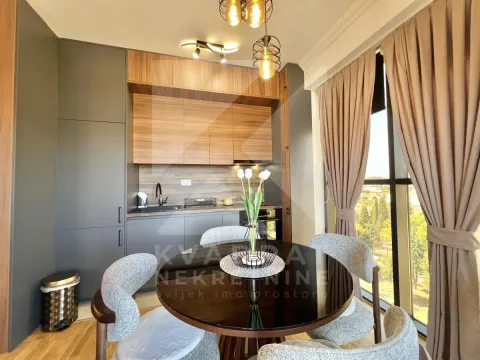 Modern kitchen with dining area and large window. - image 4