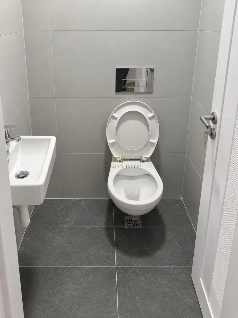 Small bathroom with a toilet and a sink.