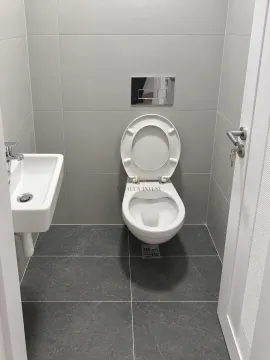 Small bathroom with a toilet and a sink. - image 8