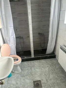 Bathroom with shower stalls and toilet. - image 5