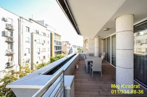 Spacious covered terrace with seating furniture and a city view. - image 11