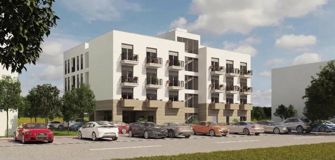 Spoljašnji izgled moderne stambene zgrade sa parkingom ispred.