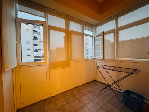 Enclosed balcony with tiled flooring. - image 8