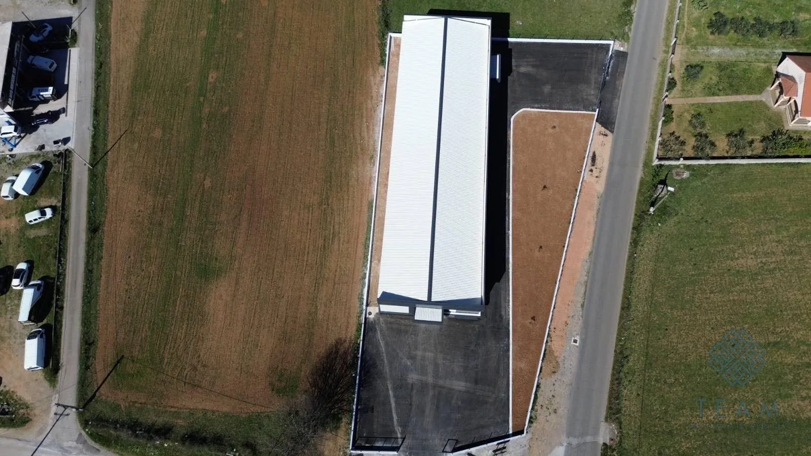 Aerial view of the building and the surrounding yard.