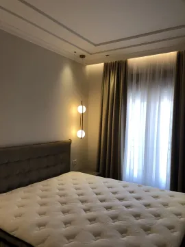 Modern bedroom with a large bed and elegant lighting. - image 9