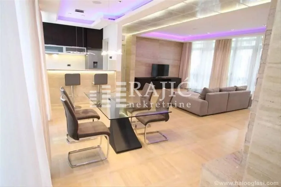 Spacious living room with dining area and modern lighting.