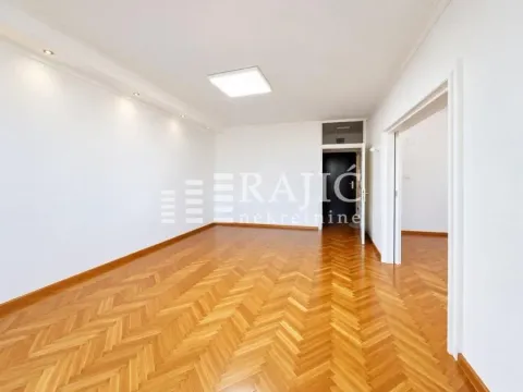 Empty room with parquet flooring and white walls. - image 2