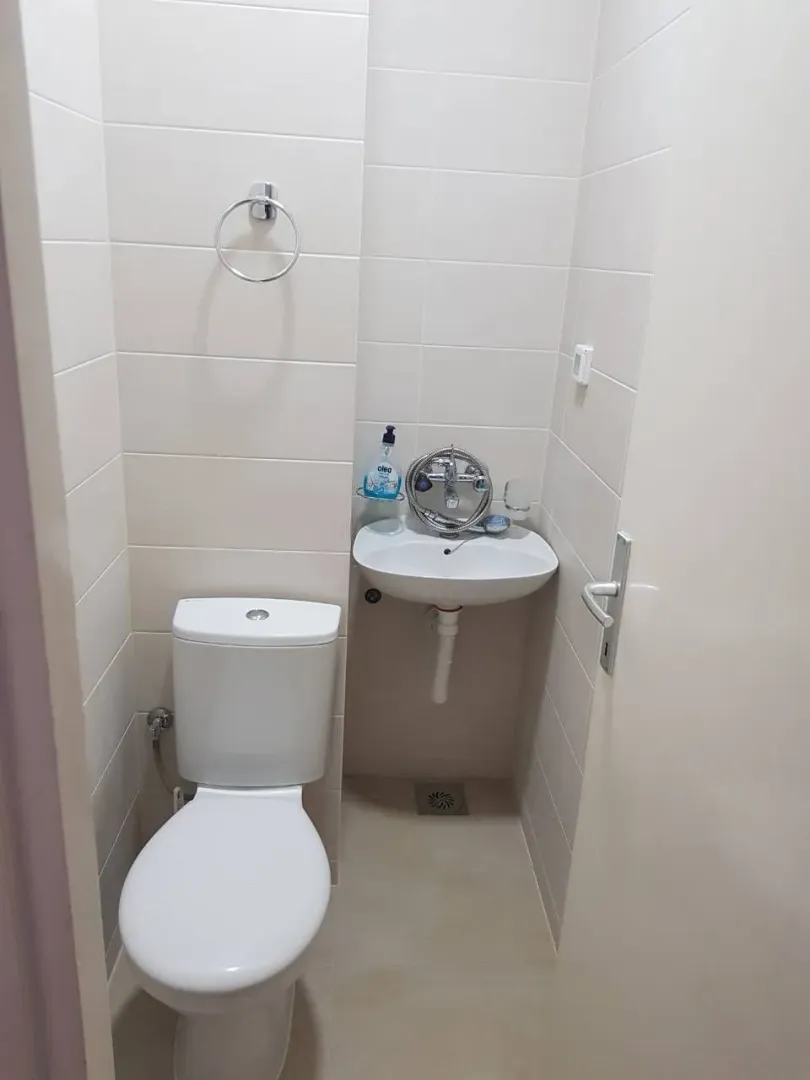 A small restroom with a toilet and a sink.