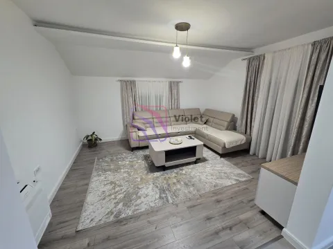 Living room with a sectional sofa, coffee table, and grey laminate flooring. - image 2
