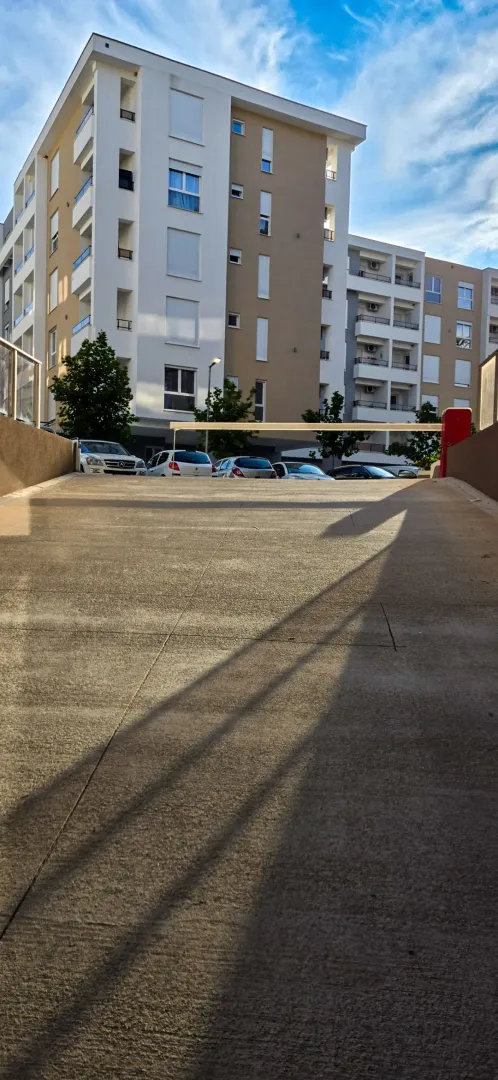 Driveway to the underground garage in front of the residential building.