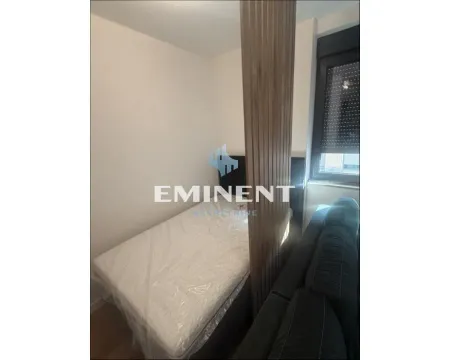 Smaller bedroom with a bed and a decorative wooden panel. - image 6