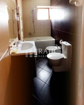 Modern bathroom with a bathtub, sink, and toilet fixtures. - image 7