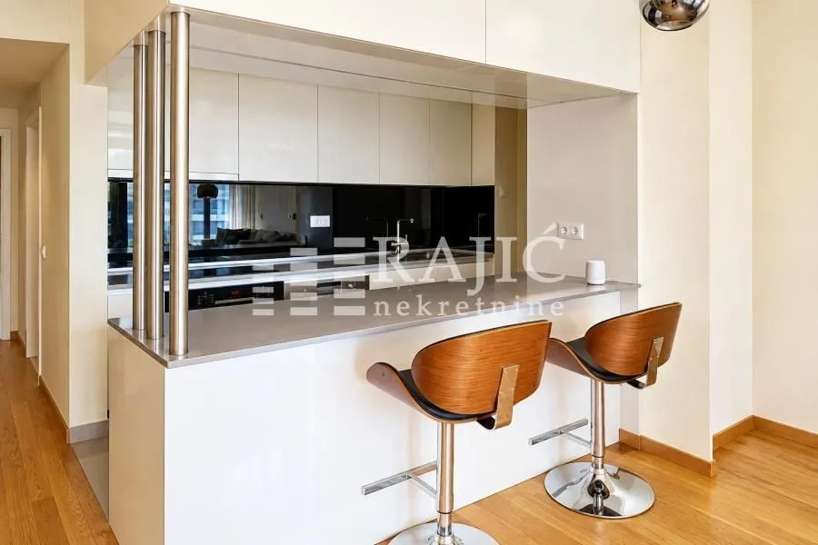 Modern kitchen with a breakfast bar and bar stools.