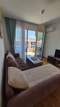 Living room with a sofa, coffee table and access to the terrace. - image 20