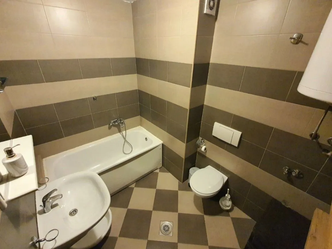 Bathroom equipped with a bathtub, sink, and toilet.