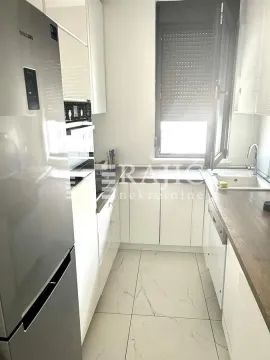 Small white kitchen with a refrigerator and a sink by the window. - image 5