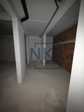 Unfinished space in gray phase of construction with pillars and installations. - image 15