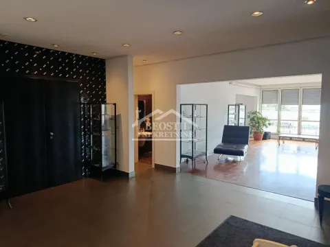 View of the spacious living room with dark tiles and wooden flooring. - image 3