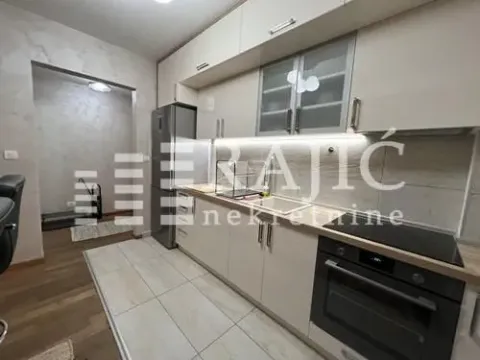 Modern kitchen with white cabinetry and built-in appliances. - image 6