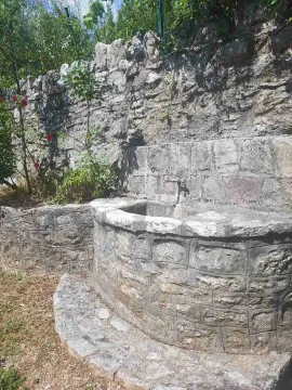 Stone yard detail with a water fountain and a natural stone wall. - image 14