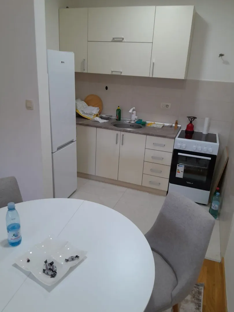 Small kitchen with a dining table and white cabinetry.