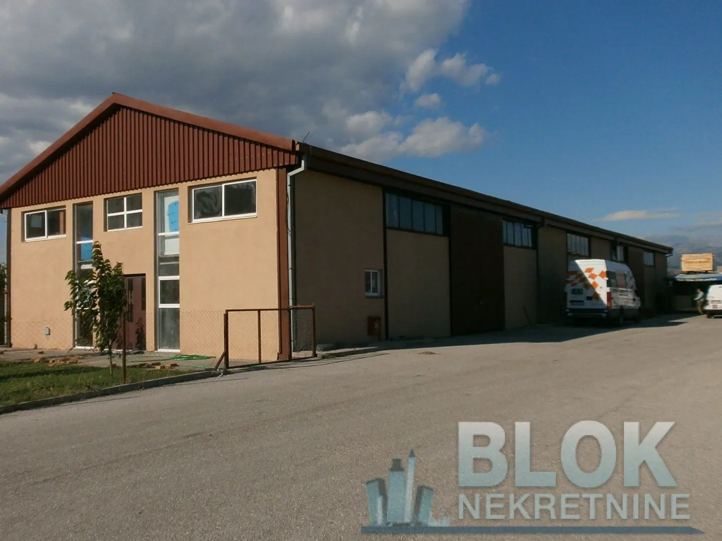 View of the exterior of an industrial building with a large courtyard.