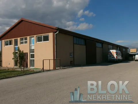 View of the exterior of an industrial building with a large courtyard. - image 4