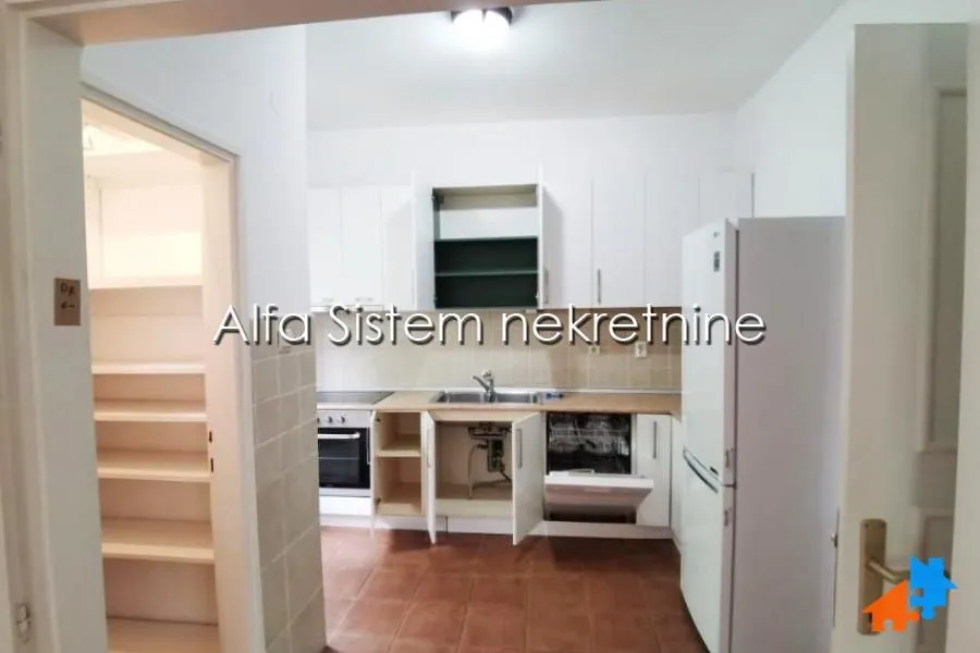 Smaller kitchen with white cabinetry and white appliances.