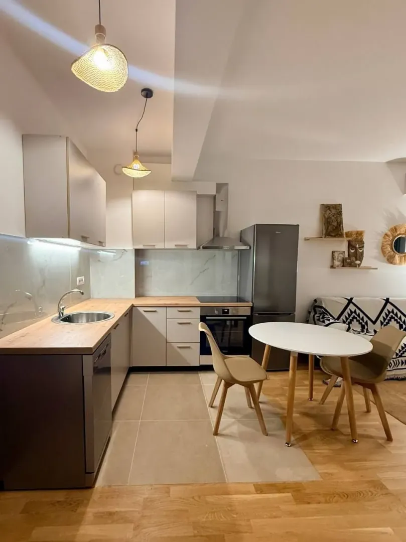 Modern kitchen with dining area and built-in appliances.