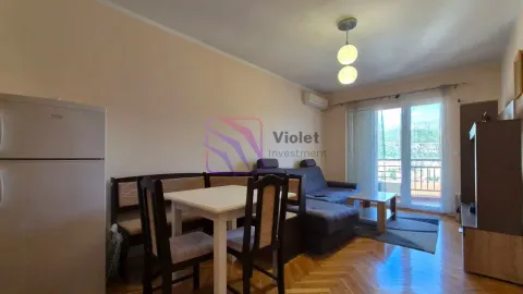 Living room with a sofa, dining table, and access to the terrace. - image 8
