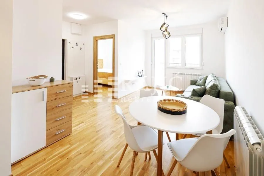 Living room with dining area and wooden flooring.