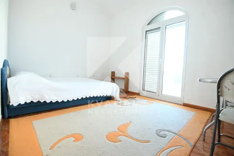 Bright bedroom with a bed and balcony doors. - image 17