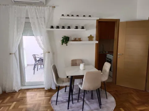Dining area with a table, chairs, and wall shelves. - image 3