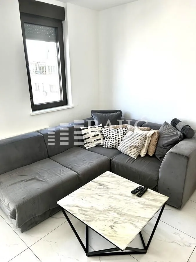 Living room with a corner sofa and a coffee table.