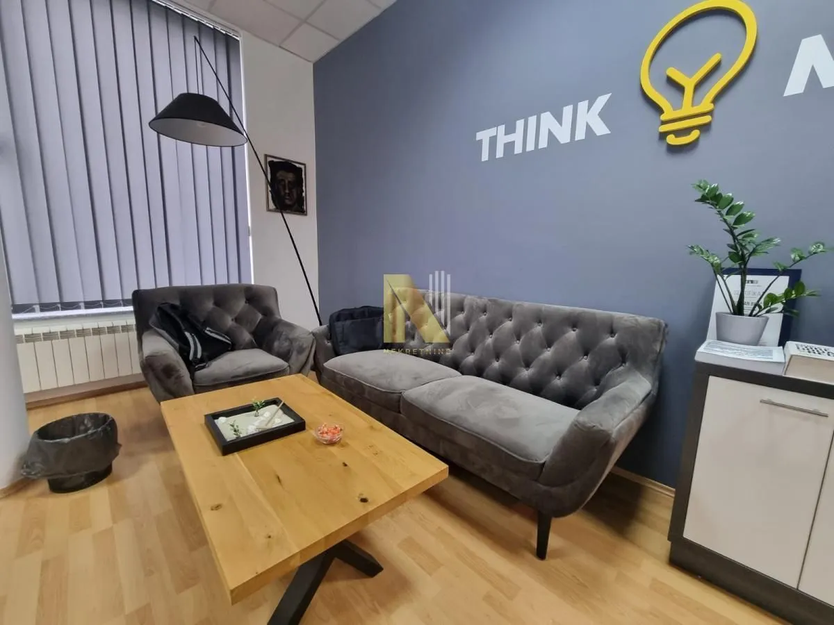 Modern office space with a seating set and a desk.