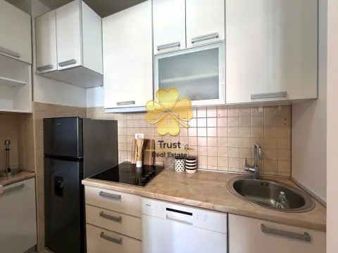 Small equipped kitchen with white cabinets and a refrigerator. - image 7