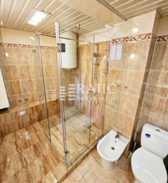 Fully equipped bathroom with a tiled walk-in shower. - image 12