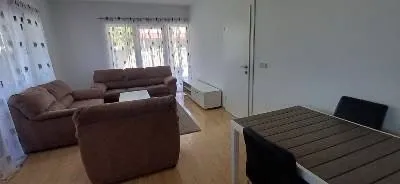 Spacious living room with seating set and dining area.