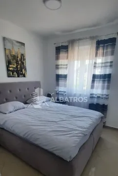 Furnished bedroom with a double bed and a window with curtains. - image 5