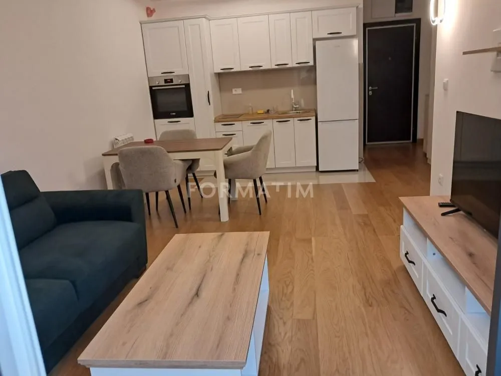 Living room with dining area and kitchen in an open space layout.