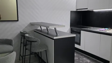 Modern kitchen with a breakfast bar and bar stools. - image 6